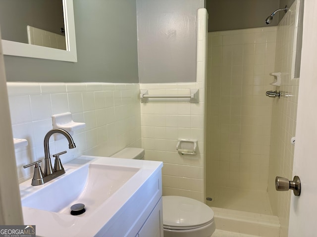 111 Howard St, Byron, GA 31008 - bathroom with toilet, tile walls, tiled shower, and a wainscoted wall