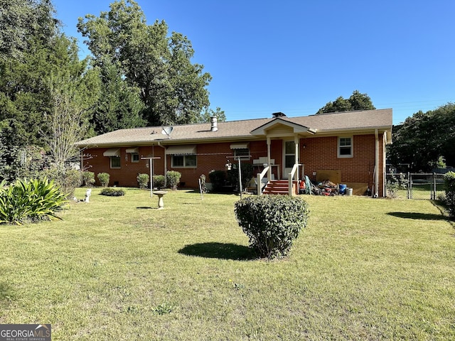 111 Howard St, Byron, GA 31008 - back of house with fence, a yard, and brick siding