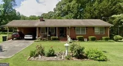 111 Howard St, Byron, GA 31008 - ranch-style home with concrete driveway, a chimney, a front lawn, and an attached carport
