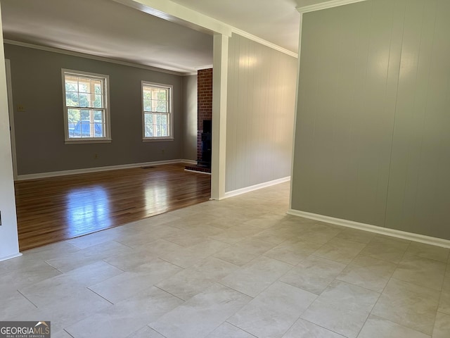 111 Howard St, Byron, GA 31008 - empty room featuring baseboards, ornamental molding, a fireplace, and light wood-type flooring