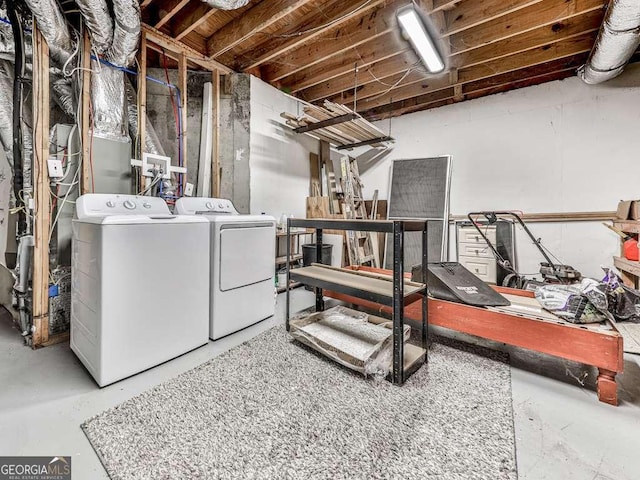 clothes washing area featuring separate washer and dryer and laundry area
