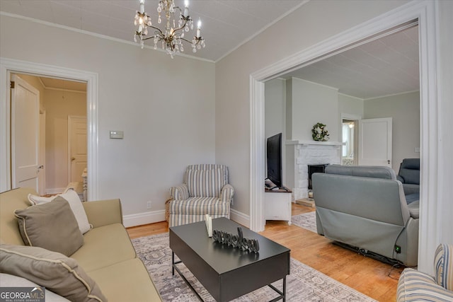 2327 Redwood Dr, Augusta, GA 30904 - living room with crown molding, a fireplace, light wood-style floors, attic access, and baseboards