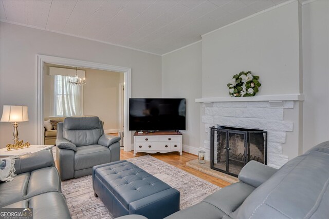 2327 Redwood Dr, Augusta, GA 30904 - living room featuring ornamental molding, wood finished floors, a chandelier, and a fireplace