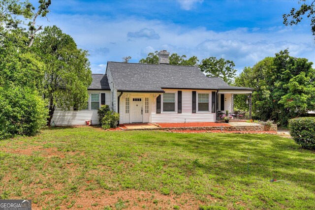 2327 Redwood Dr, Augusta, GA 30904 - view of front facade featuring roof with shingles, a chimney, and a front yard