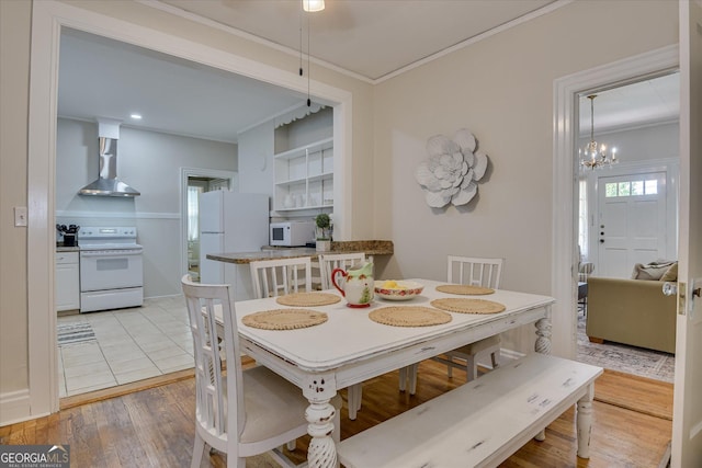 2327 Redwood Dr, Augusta, GA 30904 - dining space featuring crown molding, light wood finished floors, and a chandelier