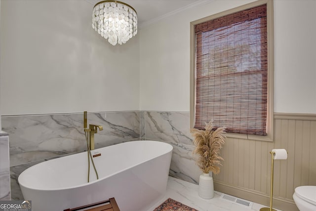2327 Redwood Dr, Augusta, GA 30904 - full bathroom featuring wainscoting, toilet, marble finish floor, a freestanding tub, and visible vents