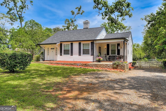 2327 Redwood Dr, Augusta, GA 30904 - view of front facade featuring fence, covered porch, a front yard, roof with shingles, and a chimney