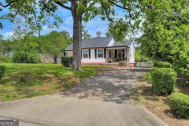 2327 Redwood Dr, Augusta, GA 30904 - view of front of property featuring fence, roof with shingles, a chimney, dirt driveway, and a porch