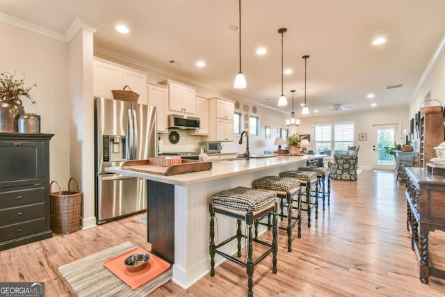 5641 Tisbury Ct, Hoschton, GA 30548 - kitchen with recessed lighting, a spacious island, appliances with stainless steel finishes, and ornamental molding