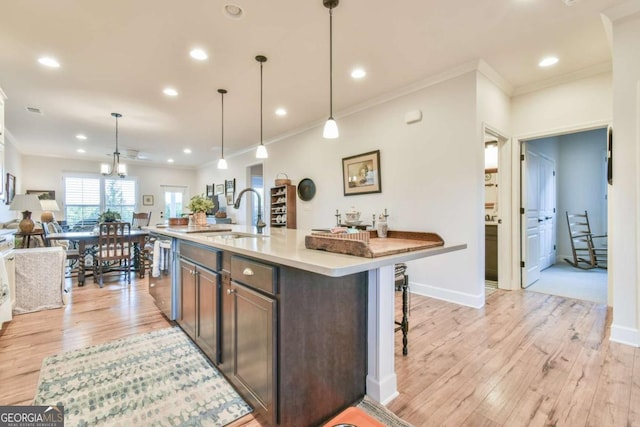 5641 Tisbury Ct, Hoschton, GA 30548 - kitchen with crown molding, a sink, light wood finished floors, and dishwasher