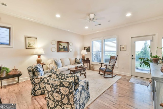 5641 Tisbury Ct, Hoschton, GA 30548 - living room featuring crown molding, a ceiling fan, visible vents, and light wood-style floors