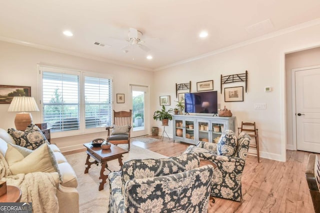 5641 Tisbury Ct, Hoschton, GA 30548 - living area with visible vents, ornamental molding, light wood-style floors, baseboards, and ceiling fan