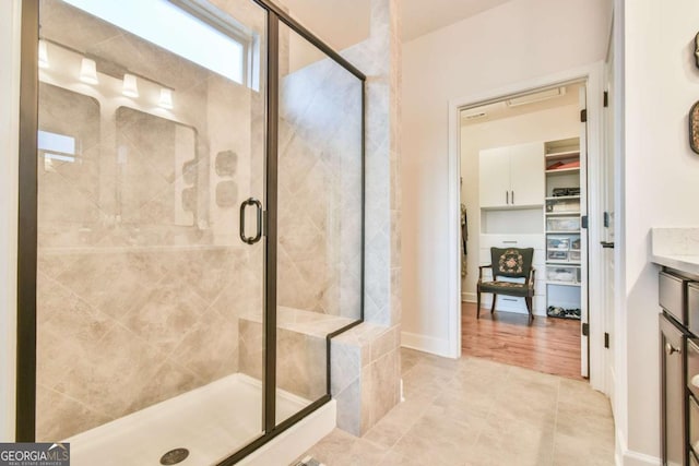 5641 Tisbury Ct, Hoschton, GA 30548 - full bath with vanity, tile patterned flooring, a stall shower, and a spacious closet