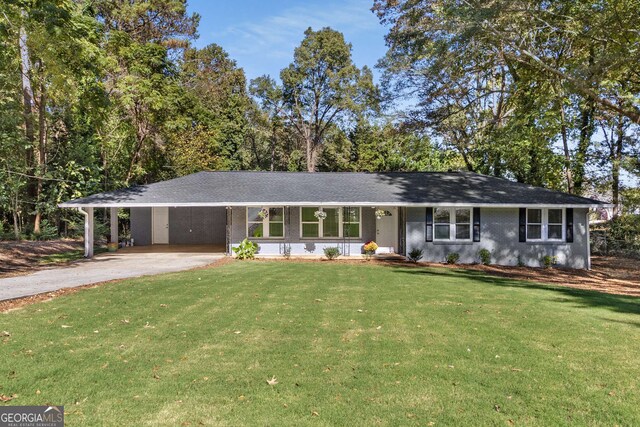 single story home featuring aphalt driveway, a front yard, and a carport