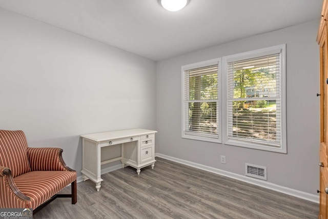 living area featuring baseboards, dark wood-style floors, and visible vents