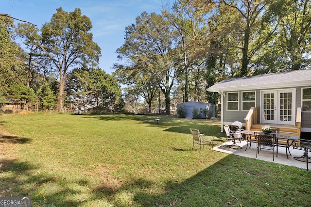 view of yard featuring french doors and a patio area