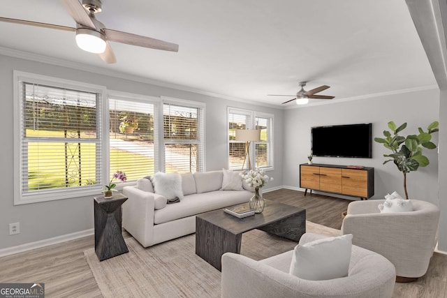 living area featuring baseboards, a ceiling fan, wood finished floors, and ornamental molding