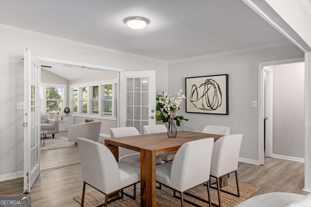 dining area featuring french doors, baseboards, and wood finished floors
