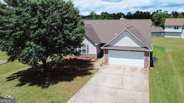 view of front of house with driveway, a front yard, an attached garage, a shingled roof, and stone siding
