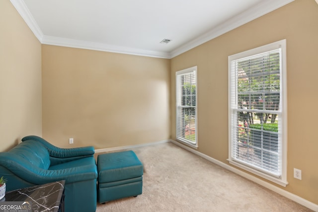sitting room with ornamental molding, carpet, and baseboards