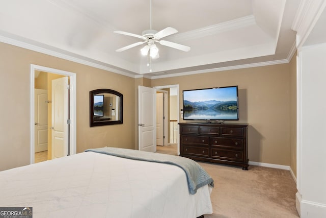 bedroom with a tray ceiling, ornamental molding, light colored carpet, ceiling fan, and baseboards