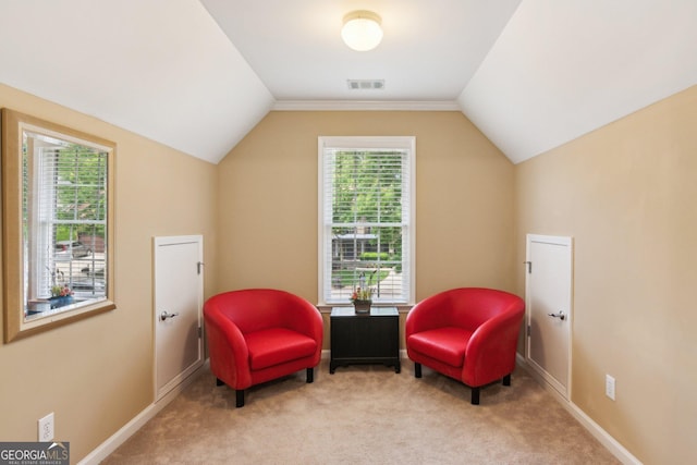 sitting room with plenty of natural light, vaulted ceiling, carpet flooring, and baseboards