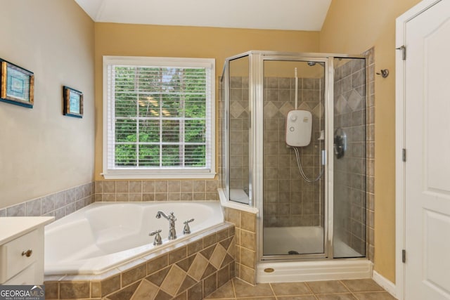 full bath with a stall shower, a bath, tile patterned flooring, and vanity
