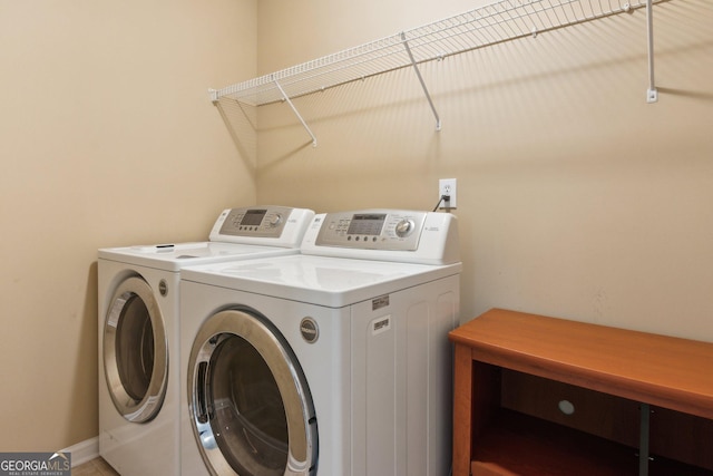 washroom featuring washer and clothes dryer