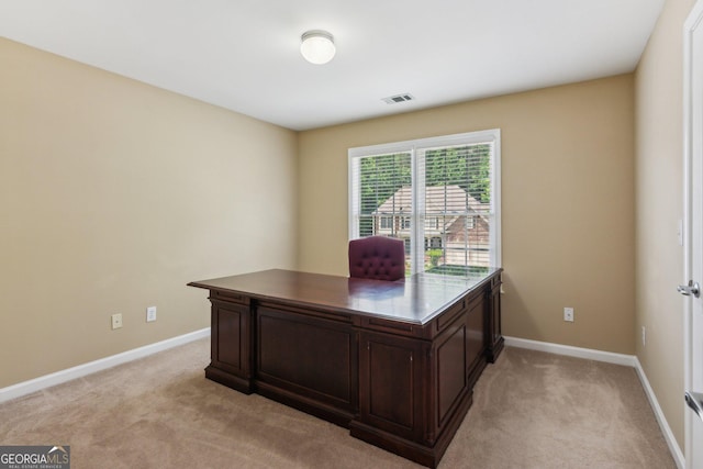 office space with light carpet and baseboards