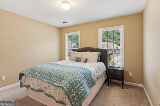 carpeted bedroom with baseboards