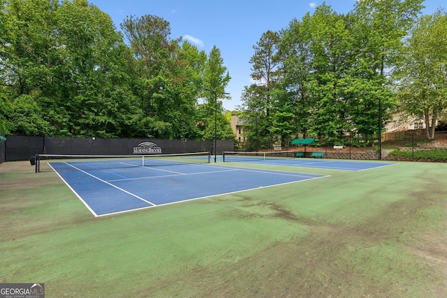 view of tennis court with fence and community basketball court