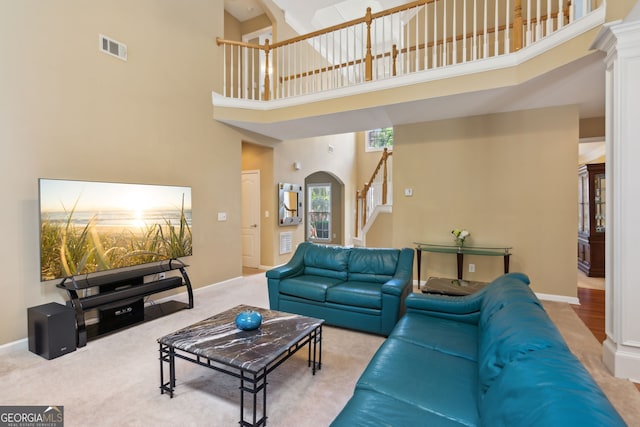4114 Suwanee Trail Dr, Buford, GA 30518 - living area featuring a high ceiling, stairs, arched walkways, and carpet flooring