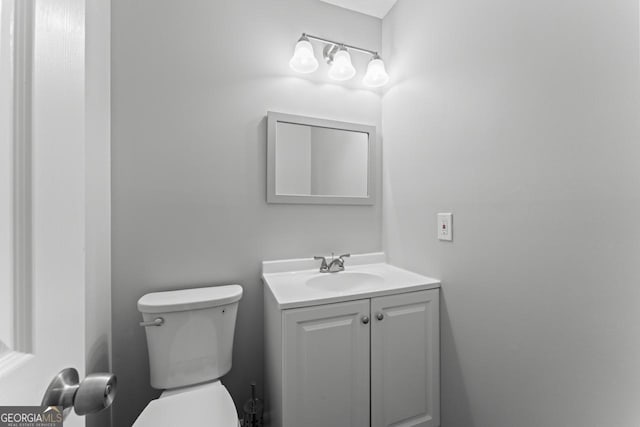 bathroom with toilet and vanity