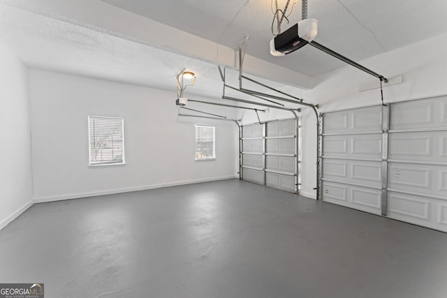garage with baseboards and a garage door opener