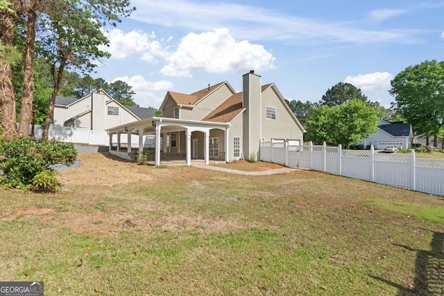 back of property featuring a porch, fence, a yard, and a chimney