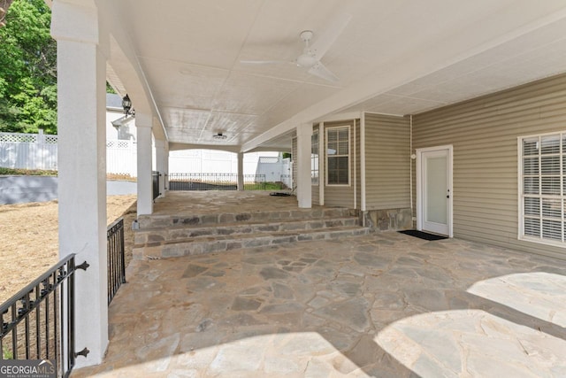 view of patio / terrace with fence and a ceiling fan