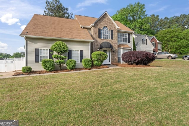 traditional-style home with fence, a gate, and a front yard