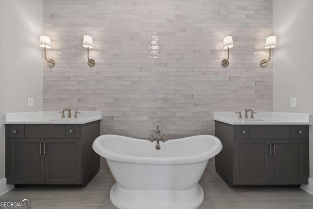 7285 Cordery Rd, Cumming, GA 30040 - full bath with a sink, a freestanding tub, two vanities, and tile walls