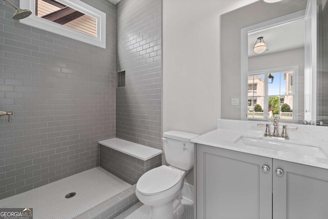 7285 Cordery Rd, Cumming, GA 30040 - bathroom featuring toilet, tiled shower, and vanity
