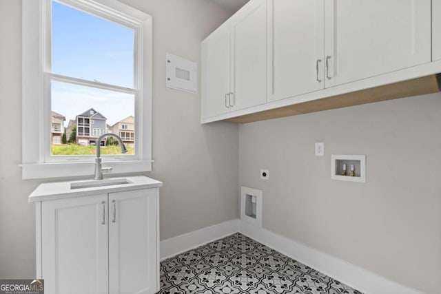 7285 Cordery Rd, Cumming, GA 30040 - clothes washing area with cabinet space, a sink, hookup for a washing machine, baseboards, and hookup for an electric dryer