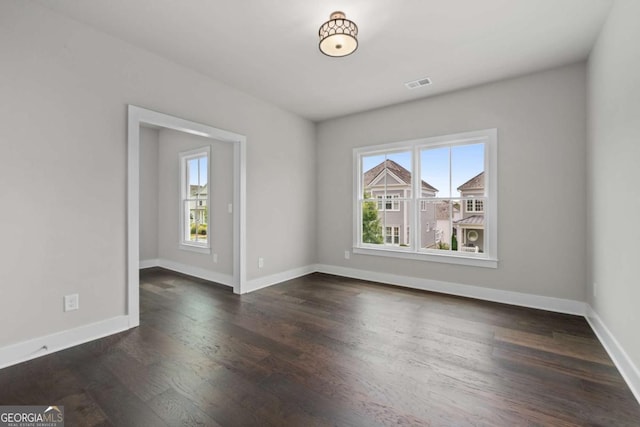 7285 Cordery Rd, Cumming, GA 30040 - spare room with baseboards, dark wood-type flooring, and visible vents