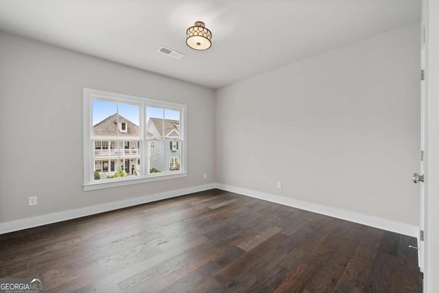 7285 Cordery Rd, Cumming, GA 30040 - spare room featuring baseboards, dark wood-style flooring, and visible vents