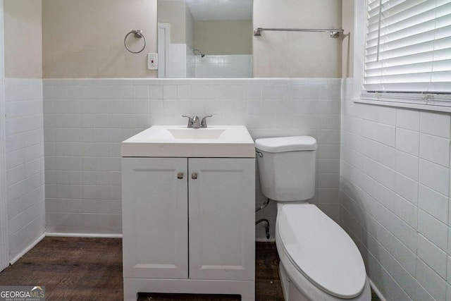 1774 Austin Dr, Decatur, GA 30032 - bathroom featuring wainscoting, vanity, toilet, tile walls, and wood finished floors