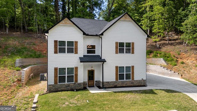 830 Dixon Dr, Gainesville, GA 30501 - view of front facade featuring a front yard, stone siding, a patio, cooling unit, and roof with shingles