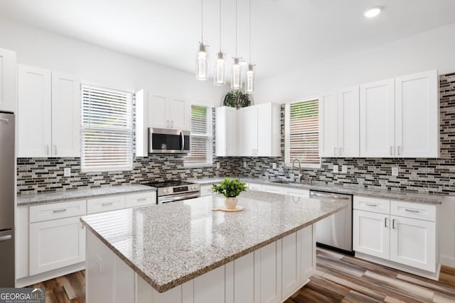 830 Dixon Dr, Gainesville, GA 30501 - kitchen featuring a sink, decorative backsplash, stainless steel appliances, and white cabinetry