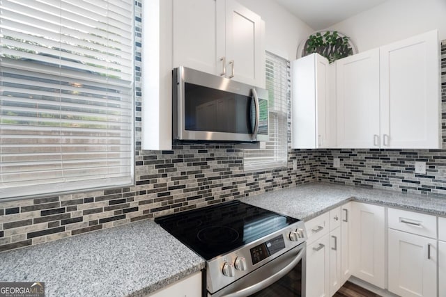 830 Dixon Dr, Gainesville, GA 30501 - kitchen featuring white cabinets, appliances with stainless steel finishes, light stone counters, and tasteful backsplash