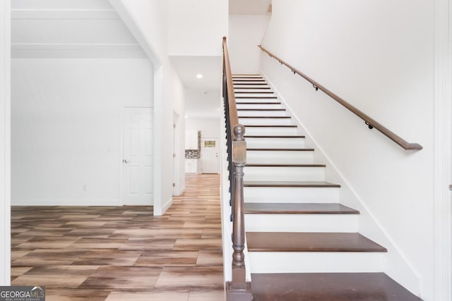 830 Dixon Dr, Gainesville, GA 30501 - staircase with recessed lighting, baseboards, wood finished floors, and a high ceiling
