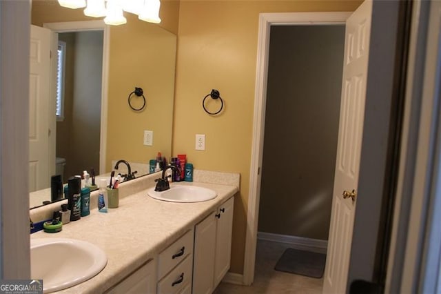 bathroom with a sink and double vanity