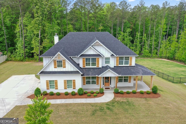 152 Creekrise Pl, Palmetto, GA 30268 - view of front facade featuring a porch, roof with shingles, a chimney, board and batten siding, and a forest view