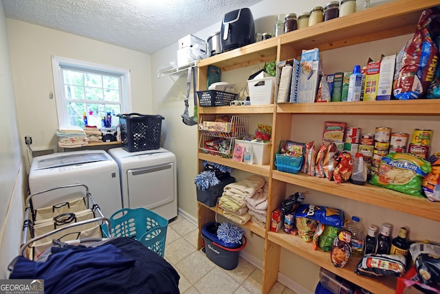 laundry room with separate washer and dryer, laundry area, baseboards, and a textured ceiling